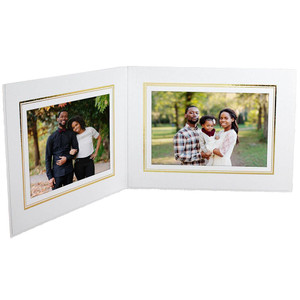 Horizontal white cardboard photo folder holds two pictures side by side Horizontal white cardboard photo folder holds two pictures side by side