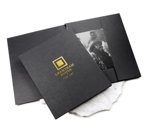 Black photo case with gold foil logo imprint on the front cover. Black photo case with gold foil logo imprint on the front cover.