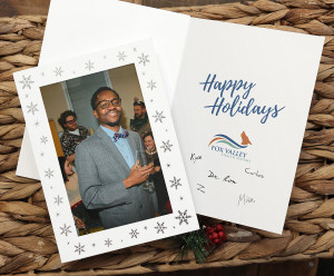 White photo card with silver snowflakes on the front and printed personalization inside the card