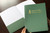 Green pocket folder with gold foil logo imprint Green pocket folder with gold foil logo imprint