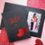 Two red hearts with company logo foil stamped on a black photo folder Two red hearts with company logo foil stamped on a black photo folder