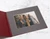 Burgundy folio lies open, showing a gray photo mat inside.