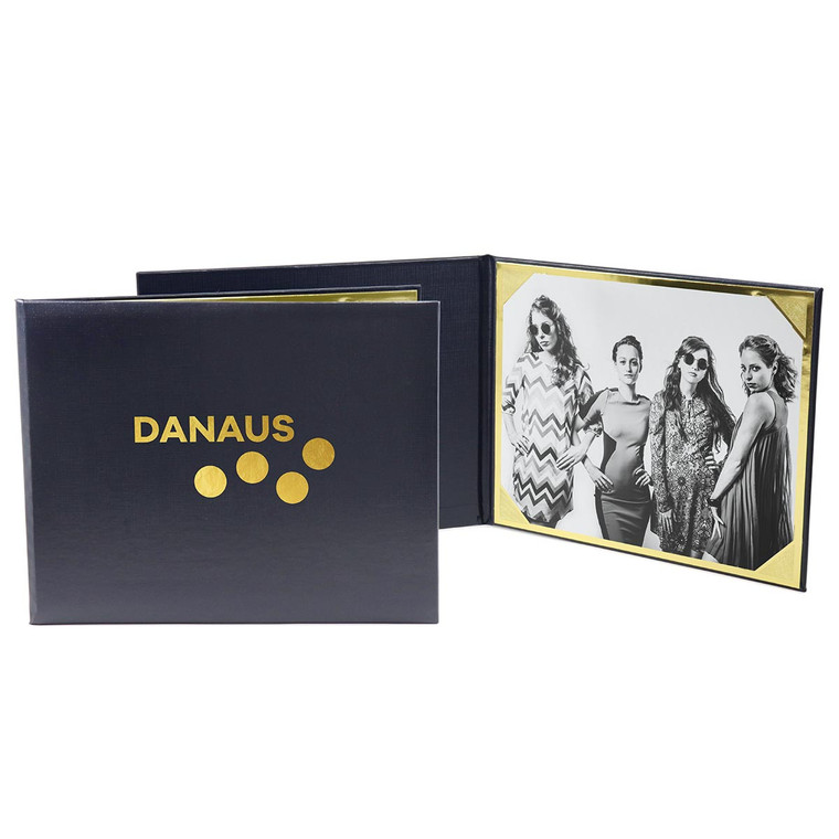 Personalized navy blue portrait folio with gold foil logo imprint and gold 8x10 horizontal frame corners inside.