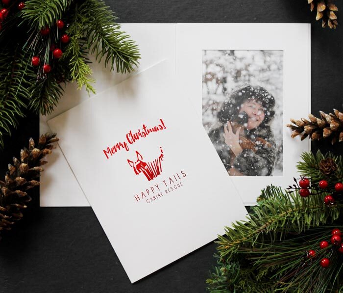 White photo folder with dog rescue logo foil stamped in red on the front cover.