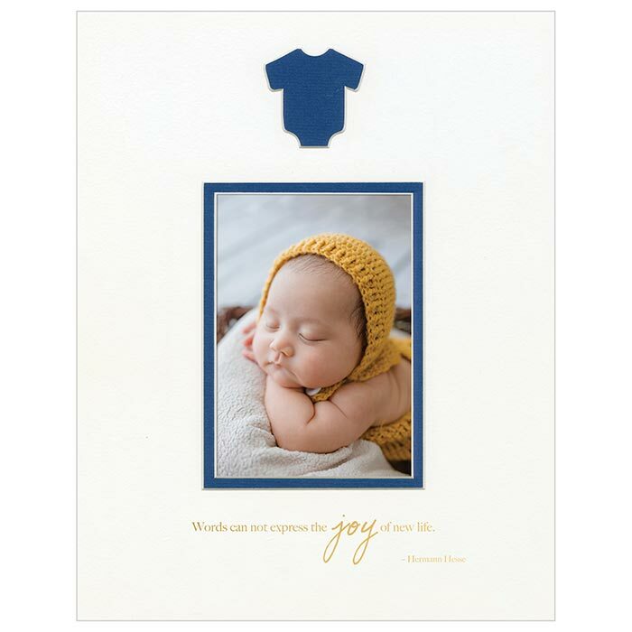 White mat with baby onesie cut-out revealing a navy blue mat below.