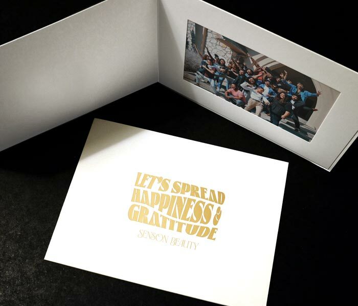 White photo event folder with a gold foil quote imprint on the front cover