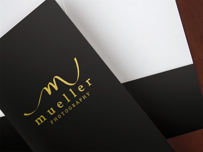 Black mini pocket folder with gold foil stamped logo on the front cover