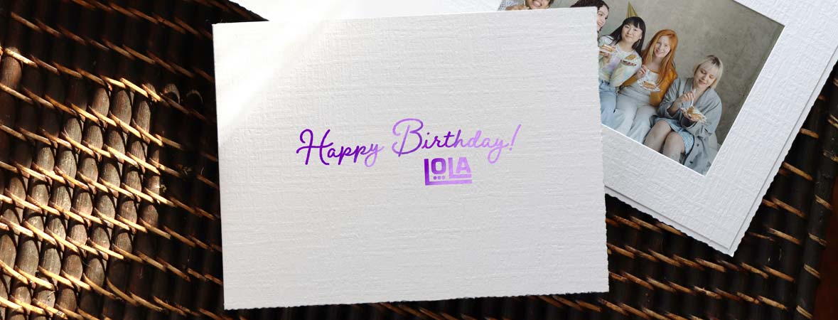 White cardboard portrait folder with purple foil logo imprint