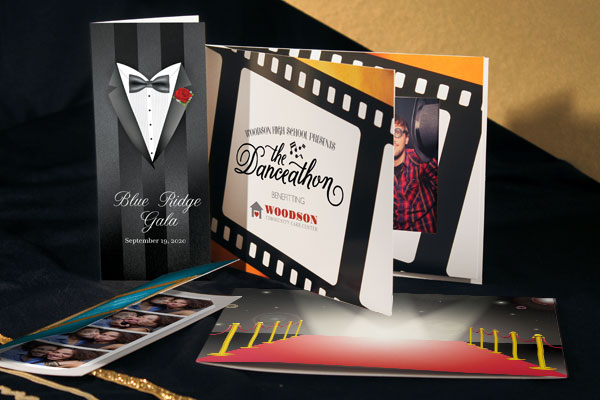 Red carpet-themed photo folders personalized with event branding