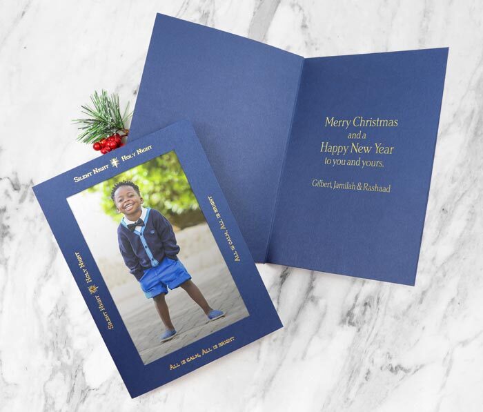 Blue photo insert card with gold foil silent night greeting on the frame.