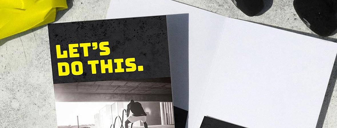 Black and yellow pocket folder that says, Let's do this above a picture of a man working out.