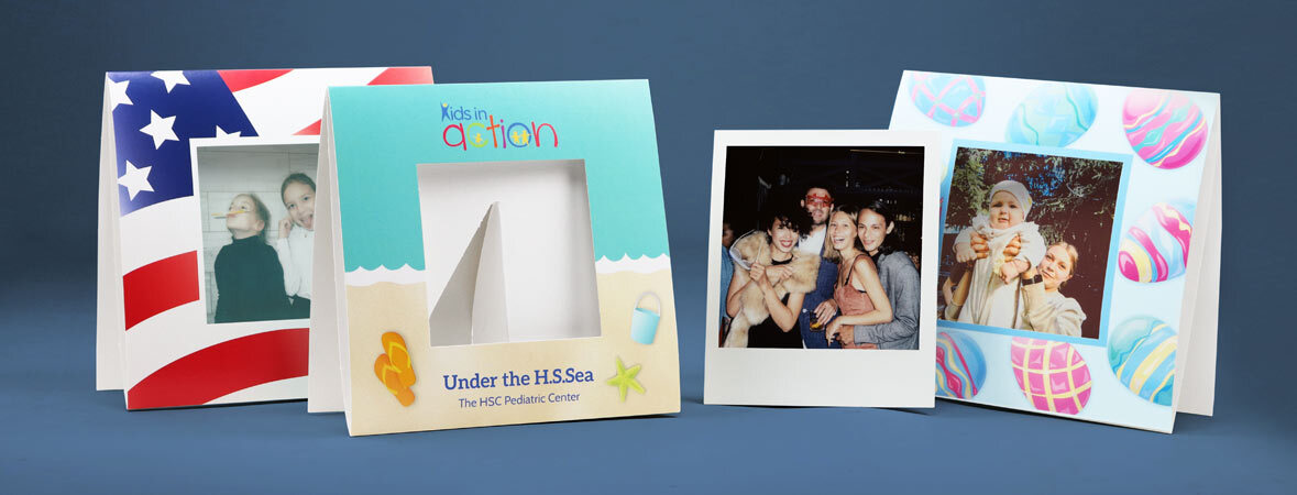 A group of themed paper Polaroid frames with a Polaroid print to show the frame's size
