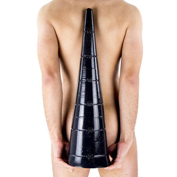 Naked man carrying big black cone shaped dildo behind