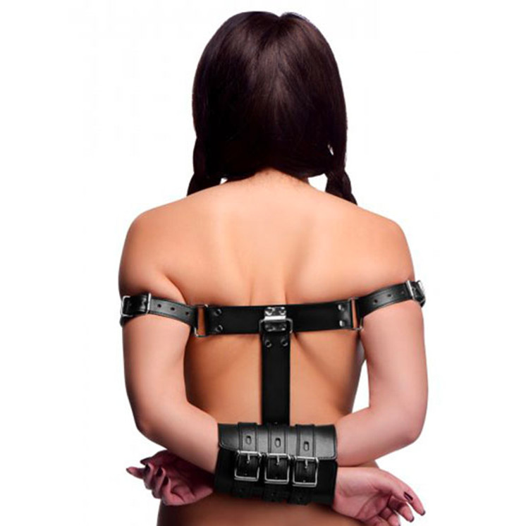 Girl tied with black adjustable arm restraint bondage