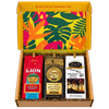 Open Hawaii Coffee Company gift box lined with tropical floral pattern, holding three ground coffee bags: Lion Original Roast, Royal Kona Private Reserve, and Hawaiian Isles Breakfast Blend