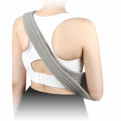A person wearing a grey arm sling over a white sports bra and black bottoms.