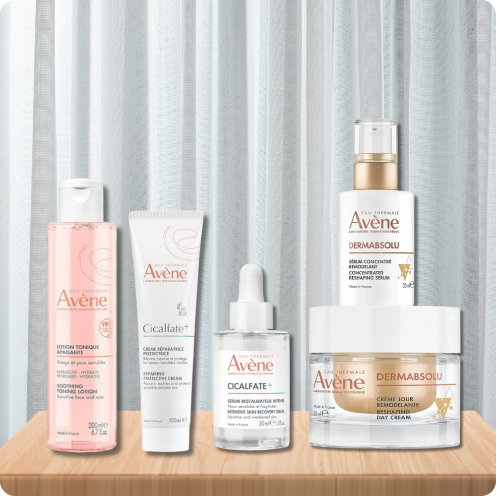 a range of Avene Skincare on a wooden plinth in front of a white curtain
