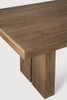 Close-up solid teak grain and block legs of Ethnicraft extendable dining table