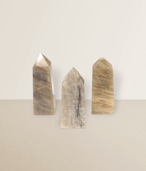 Moonstone - a variety of points in various sizes, against a light cream background.