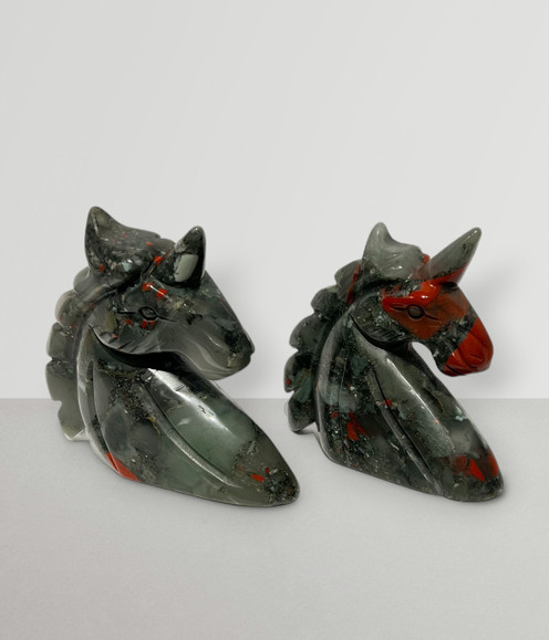 Bloodstone Unicorn Bust Carvings, two sample angled to the side, front-facing, against a light-grey coloured background.