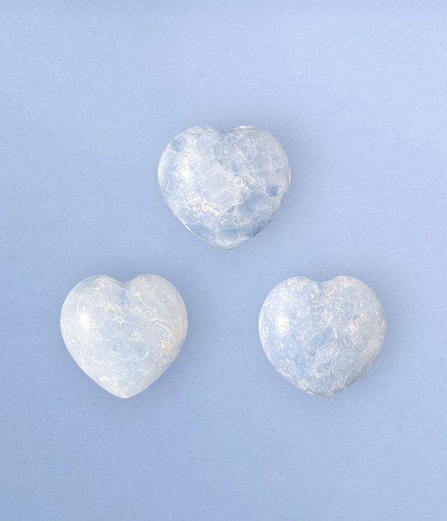 Blue Calcite Palm Hearts - a variety of hearts in medium sizes, against a cool blue background.