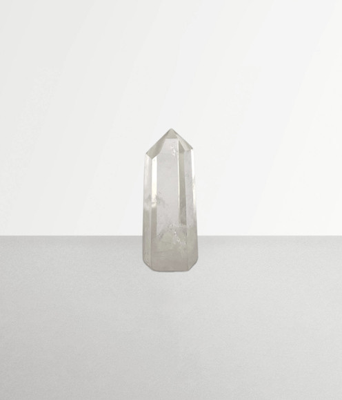 Clear Quartz - a sample of points in small-sized pieces against a pale grey background. Clear Quartz - a sample of points in small-sized pieces against a pale grey background.