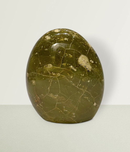 Green Opal Free Form - solo piece #3, from the front, against a light lime coloured background. Green Opal Free Form - solo piece #3, from the front, against a light lime coloured background.