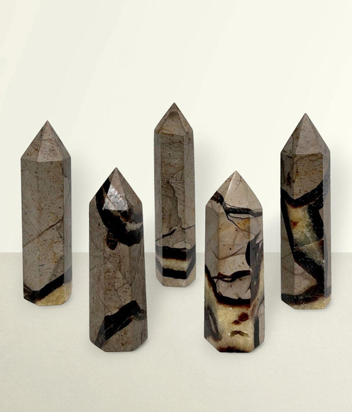 Septarian Points - a variety of pieces in small & medium sizes, against a light cream coloured background.