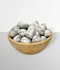 Howlite - a bowl of assorted tumbled pieces, against a light grey coloured background. Howlite - a bowl of assorted tumbled pieces, against a light grey coloured background.