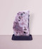 Pink Amethyst Slab Display #5, standing upright in a base stand, front-facing, against a light pink background.