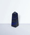 Lapis Lazuli Point - unique piece #5, from the back, against a light blue background.