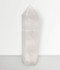 Clear Quartz Point - solo piece #1, from the front, against a pale grey background.