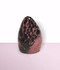 Rhodonite Free Form - solo piece #3, from the front, against a light pink coloured background. Rhodonite Free Form - solo piece #3, from the front, against a light pink coloured background.