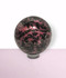 Rhodonite Orb - solo piece #1, from the front, against a light pink coloured background. Rhodonite Orb - solo piece #1, from the front, against a light pink coloured background.