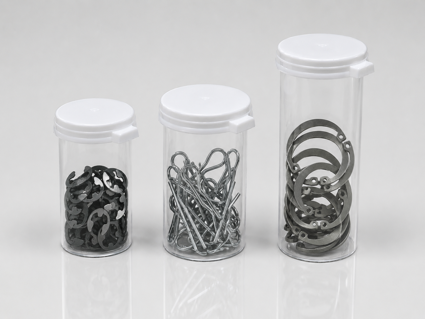 Washers and retaining clips packaged in clear plastic vials