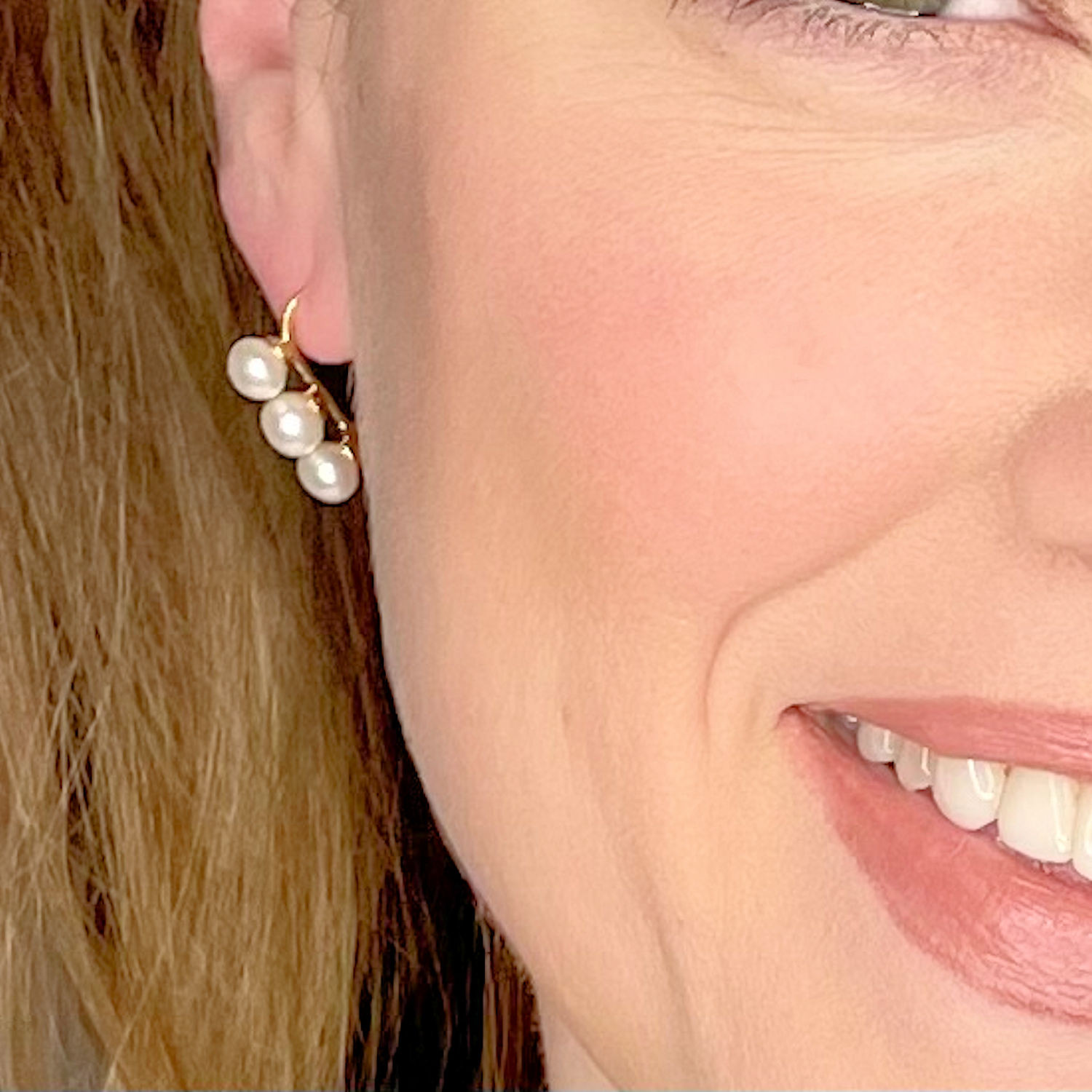 Single oval shaped white freshwater pearl earring on silver chain, Aster