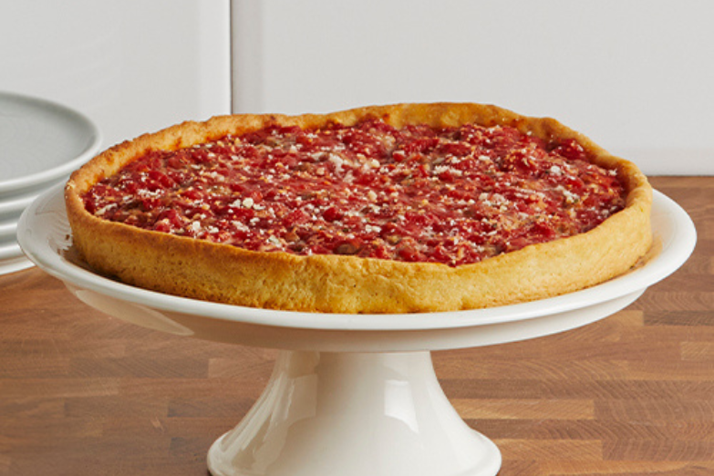 deep dish pizza on holder