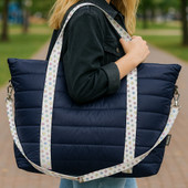 navy puffer weekender tote with rainbow stars straps
