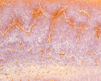 Up close image of CR-17 Flux over C-33 Sandalwood on White Chocolate No.16, fired to Cone 6.