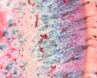 Up close image of CR-18 Speckled Flux over C-54 Snapdragon on White Chocolate No.16, fired to Cone 6.