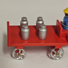 Horses Pulling Red Wagon Carrying Milk Cans - Wooden German Figurine – side view of the Christmas ornament
