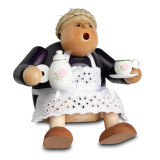 Grandmother with tableware, sitting