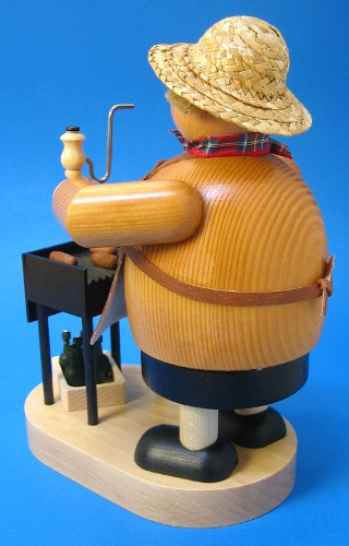 Man with His Grill German Smoker – side view of the German Christmas smoker