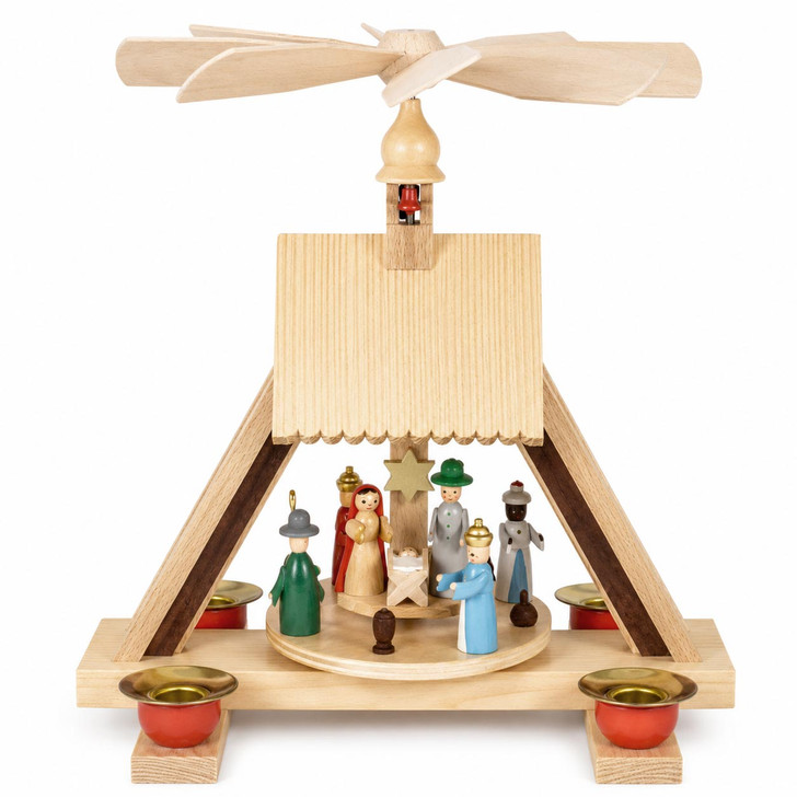 Bring the Christmas story to life with this handcrafted German Christmas Pyramid featuring the Holy Family, Three Wise Men, and shepherd. Hand-painted figures rotate beneath a golden star, powered by four pyramid candles.