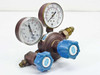Union Carbide Linde UPD-3-25-580 compressed gas pressure regulator front view showing dual gauges and blue adjustment knobs