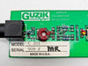 Guzik C201 calibrator board close-up of component side showing toroidal inductor T1, resistors R1 R2 R6, Guzik Technical Enterprises label, and model/serial tag