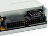 Mitsumi D359M3 floppy drive – close-up of rear connectors showing 34-pin IDE floppy data connector and 4-pin power header with dust accumulation