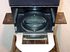 De Vere Micro condenser head open interior showing large-diameter condenser lens element from above, with De Vere Micro nameplate visible