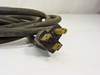 Close-up of NEMA 5-15P male plug end of power cord 8943W — brass blades visible with cable jacket markings SJ 10-3 60C