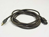 IEC C15 power cord 8943W full length coiled view — NEMA 5-15P plug visible at left, C15 connector at right
